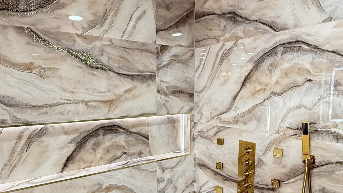 Gold ceiling-mounted shower system with body jets and marble walls