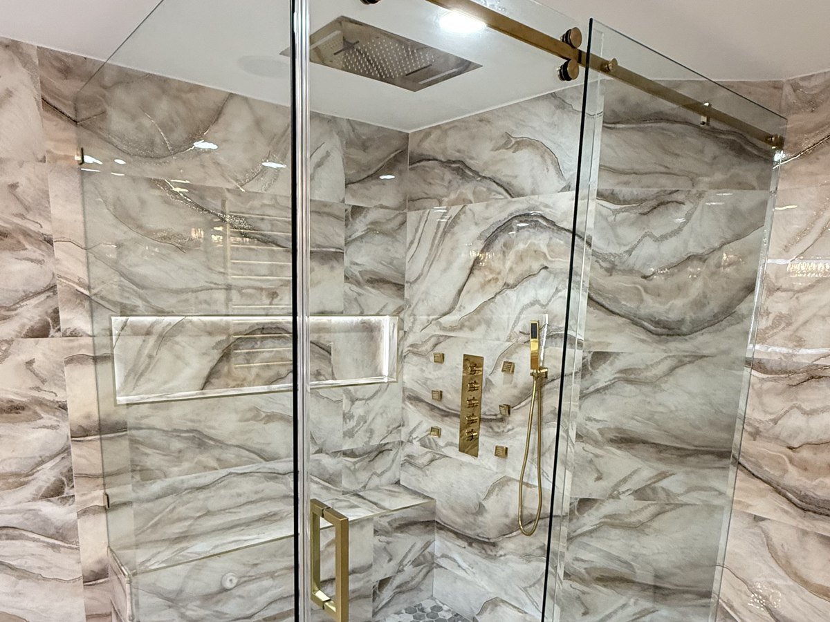 Spa-style primary bathroom with organic mirrors, South Florida bathroom remodel