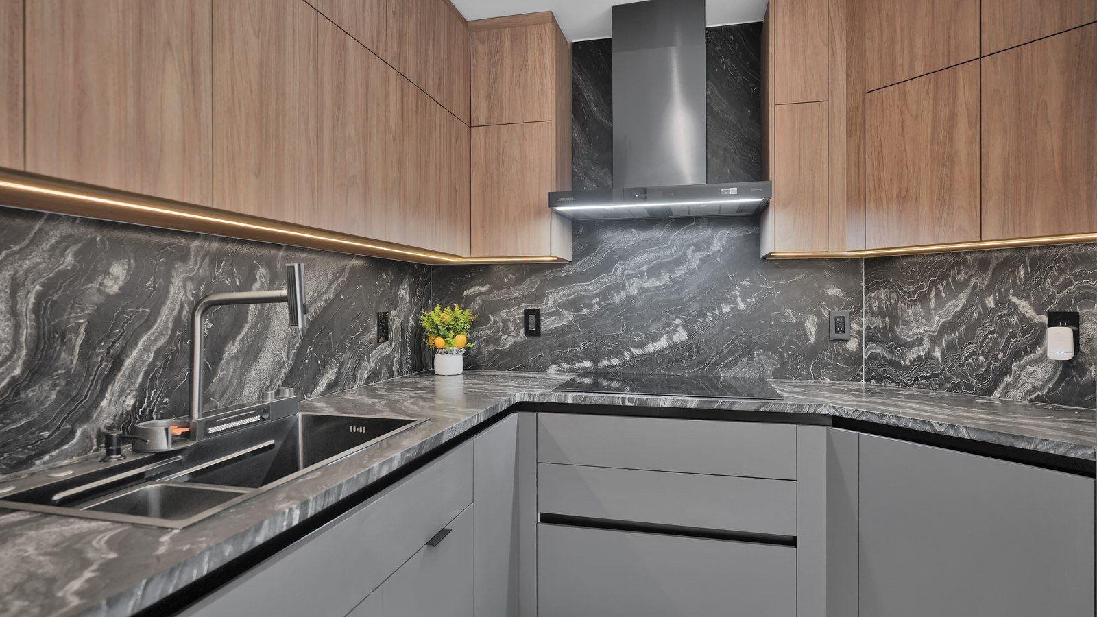 Range hood set against a full-height stone backsplash