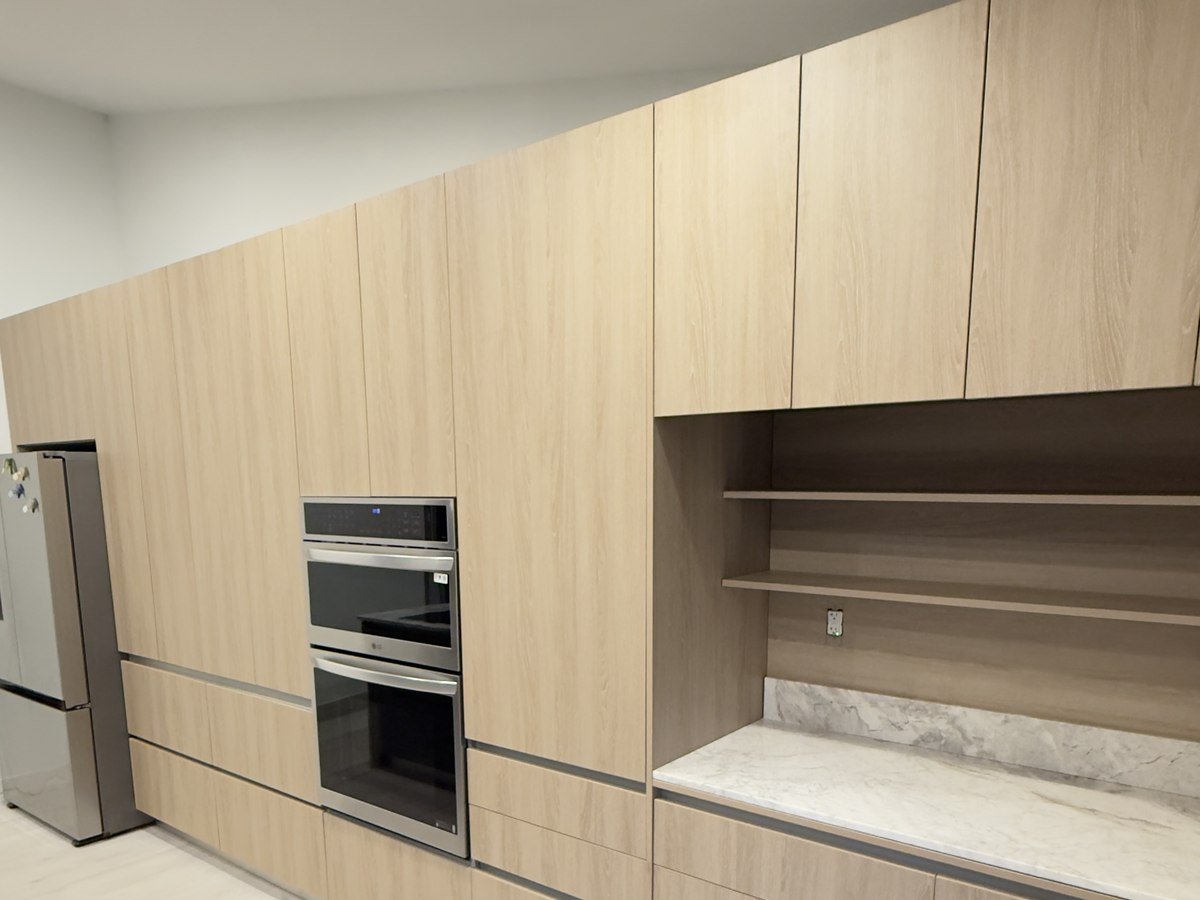 Light wood kitchen with built-in oven column and open shelving